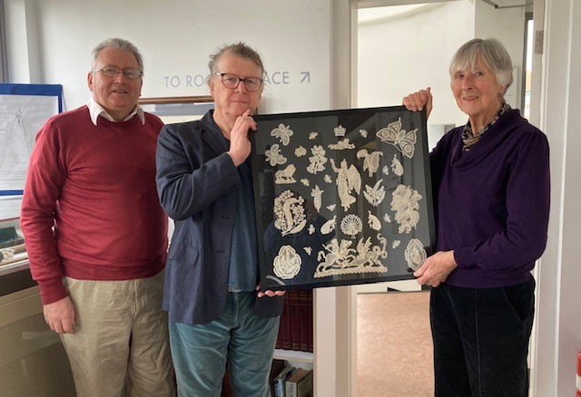 Cllr. David Cox and Richard Younger-Ross present the lace to Museum Curator Lin Watson